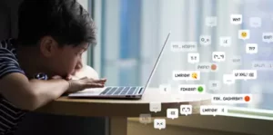 Person leaning toward a laptop with floating chat icons representing online messages and digital activity
