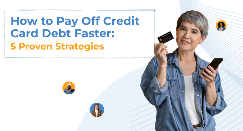 A middle-aged woman with short grey hair wears an open denim shirt and smiles as she holds up a black credit card in one hand and a smartphone in the other.