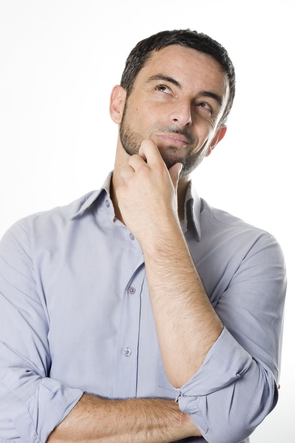 Person standing with arms crossed and hand on chin in a thoughtful pose