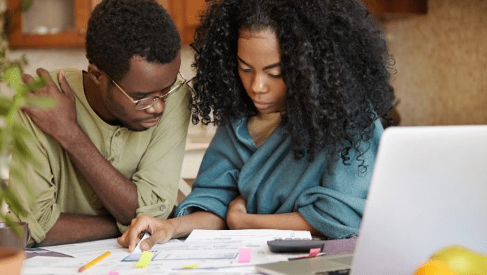 People seated at a table reviewing financial planning documents
