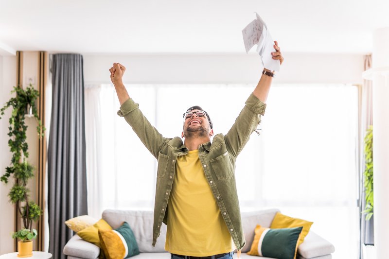A man with his arms in the air, celebrating by Century Support Services