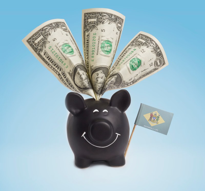 One dollar banknote in a smiling piggybank of Delaware