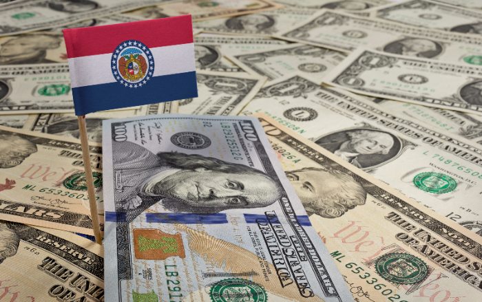 The state of Missouri flag sitting on various bank notes by Century Support Services