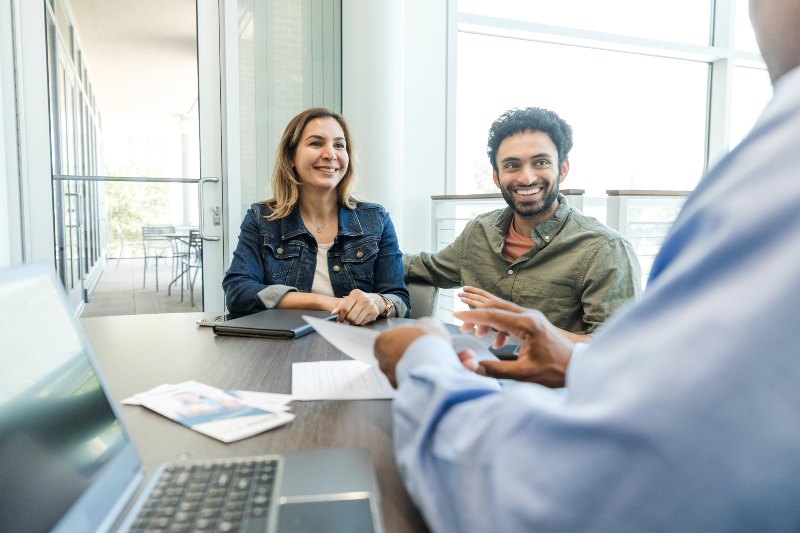 A smiling couple doing a debt relief consultation by Century Support Services