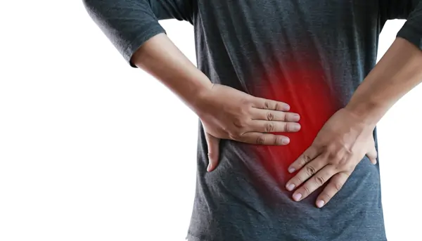 Person holding their lower back with a red-highlighted area indicating pain