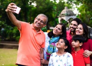 Group of people taking a selfie outdoors in a park setting