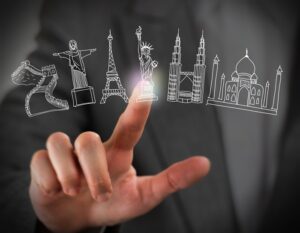 Finger touching digital icons of famous landmarks floating in a virtual interface
