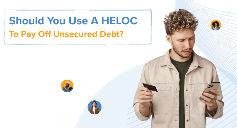 A person holding a payment card and phone, representing someone weighing whether to use home equity to pay off debt.